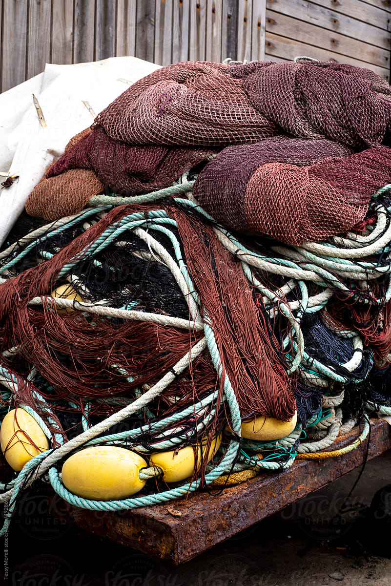 Fisherman tools and fishnets stacked on the dock