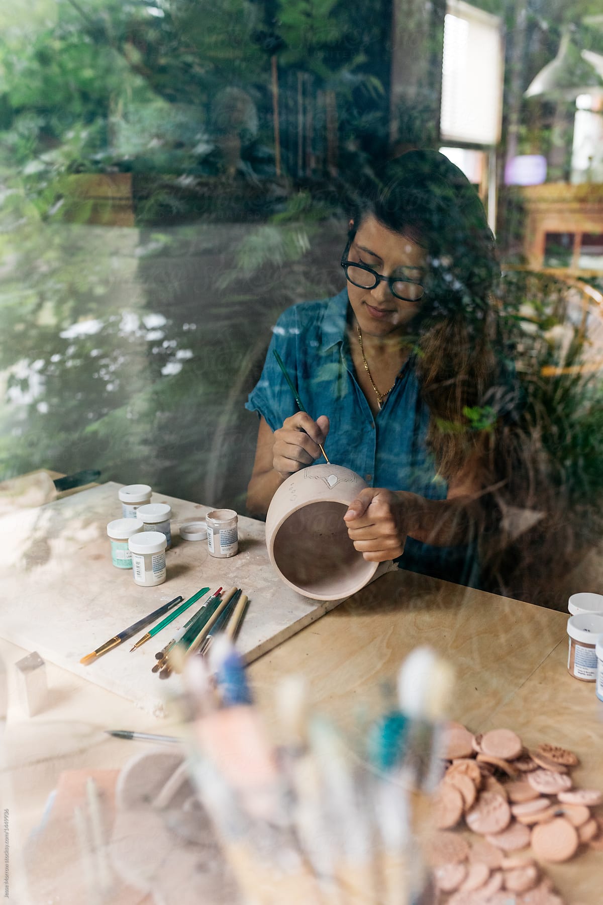 portrait of woman maker ceramics painting design on surface of pot