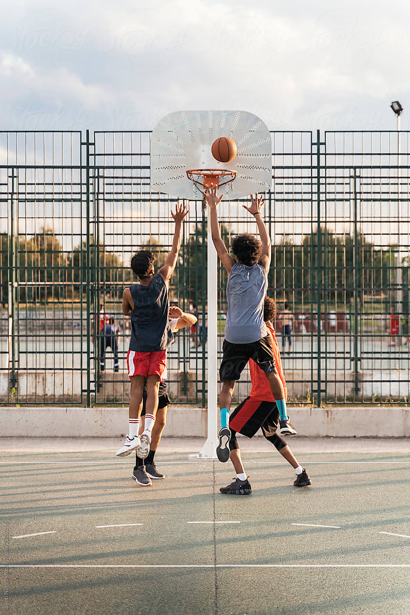 Teenager group having fun playing basketball