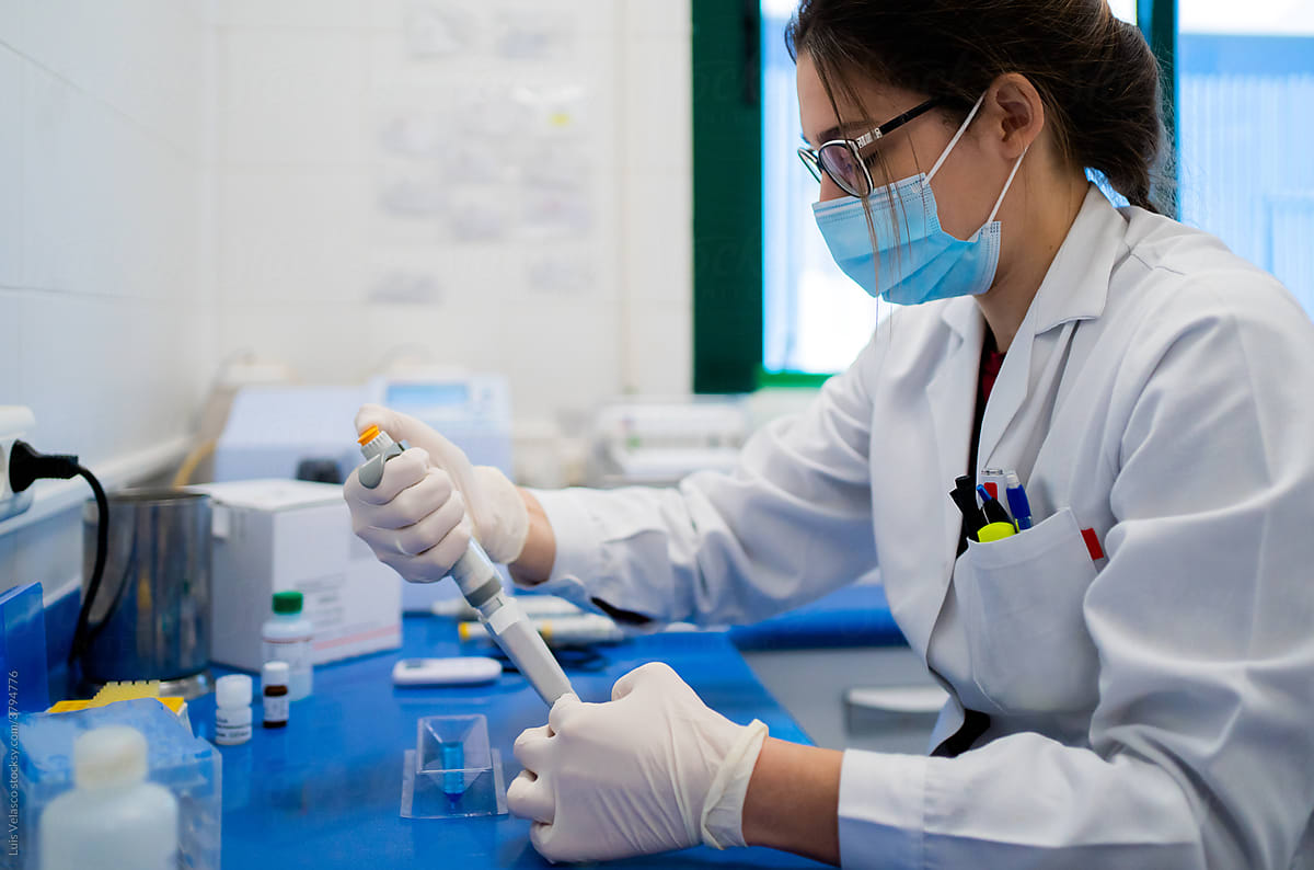 Woman Using The Pipette In Science Research In A Lab.