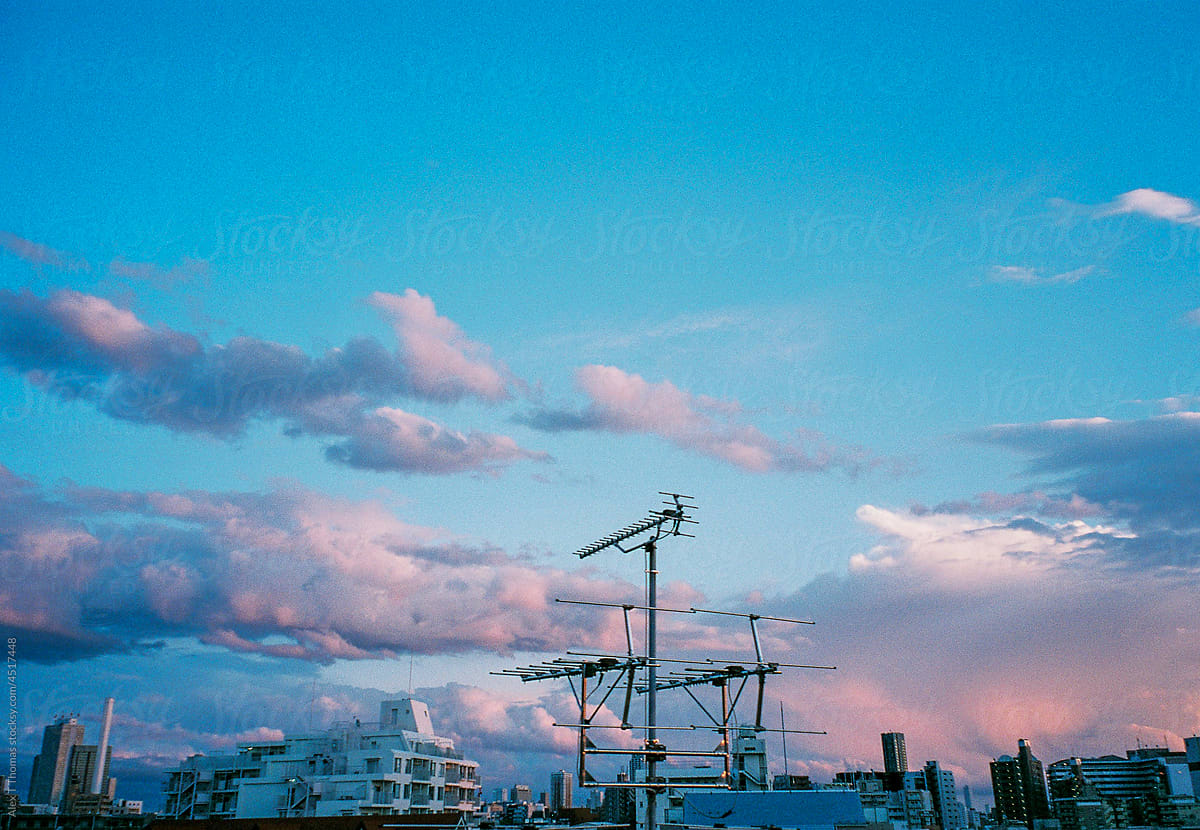 Pastel clouds over city skyline