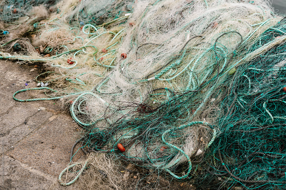 Heap of fishing nets on ground