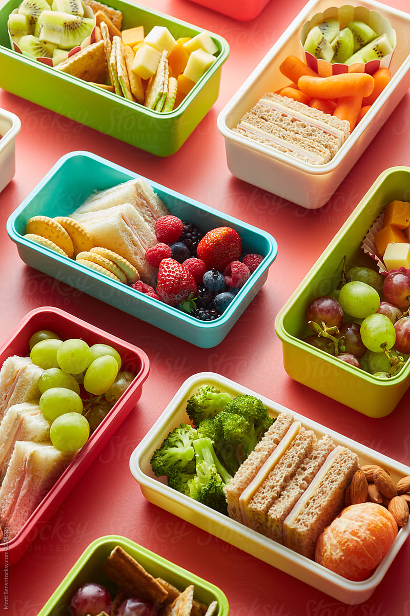 Healthy food in colorful lunchboxes.