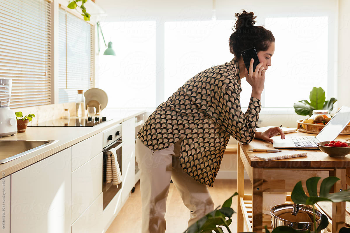 Female freelancer working in kitchen