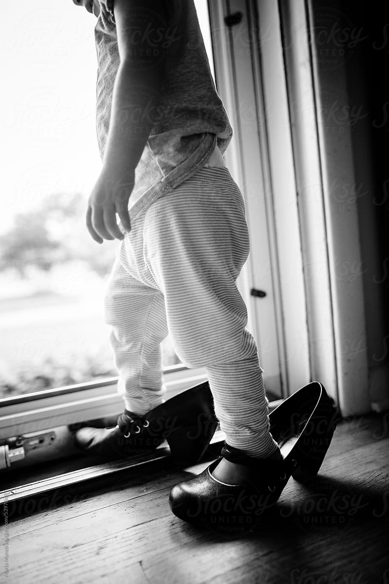 Toddler wearing mom\'s shoes