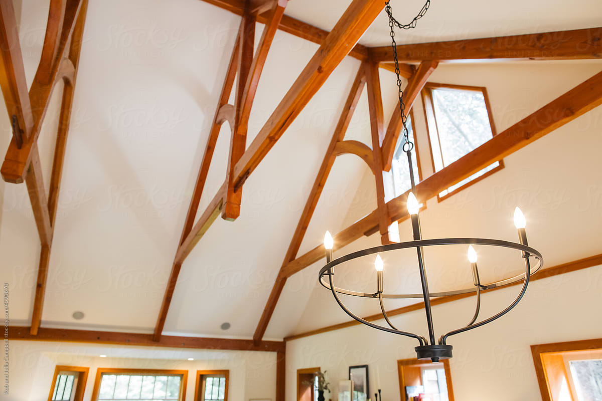 Chandelier and wooden beams in home.