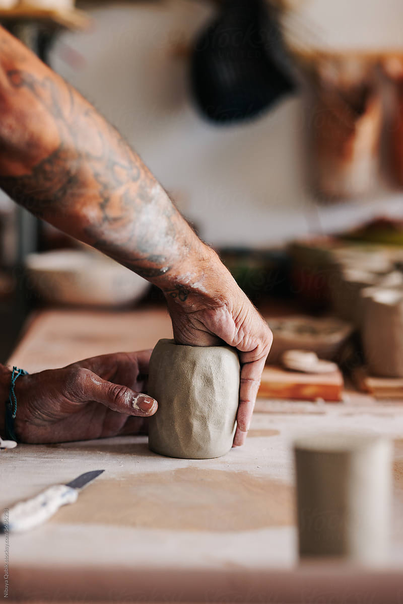 Male Ceramist hands modeling a clay vase