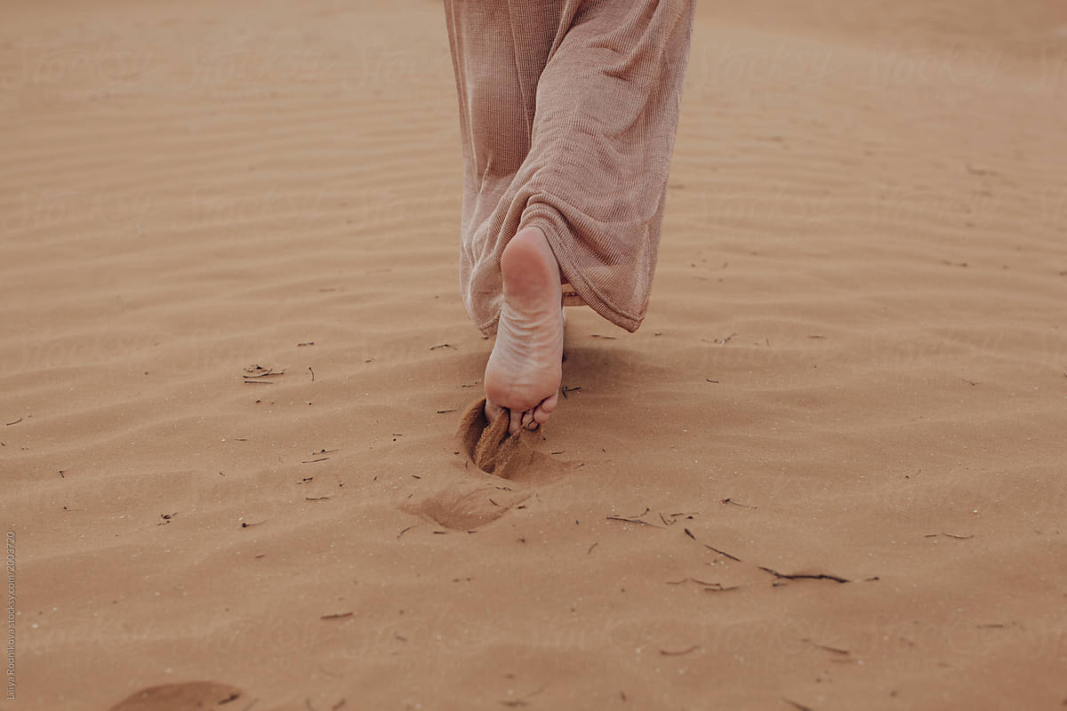 Barefoot Unrecognizable Woman Going Away In Desert by Liliya Rodnikova