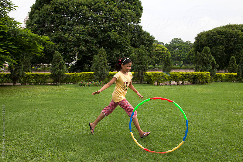 Teenage girl playing with Hula Hoop
