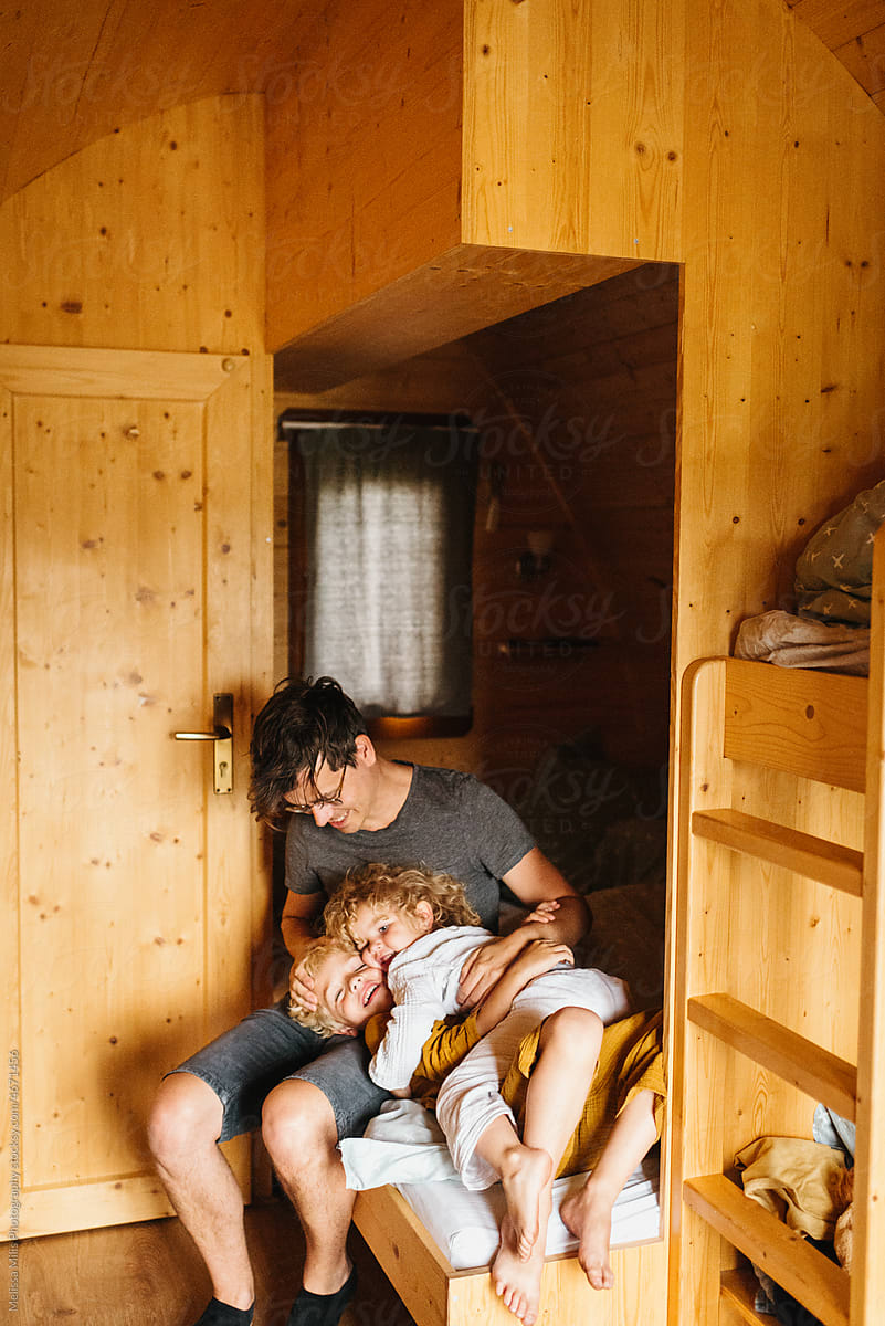 Father and kids in a tiny house with his kids being sweet