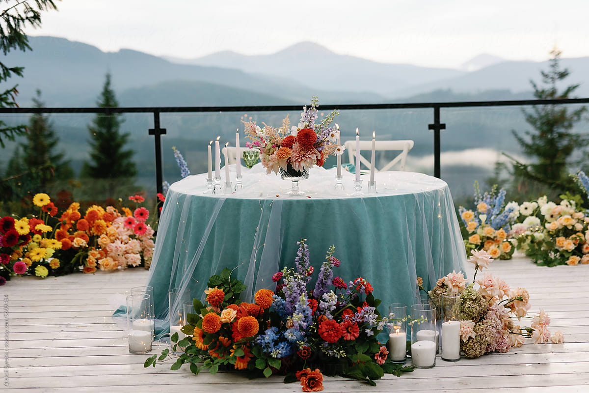 Rehearsal dinner arrangement tablescape mountain floral alfresco event