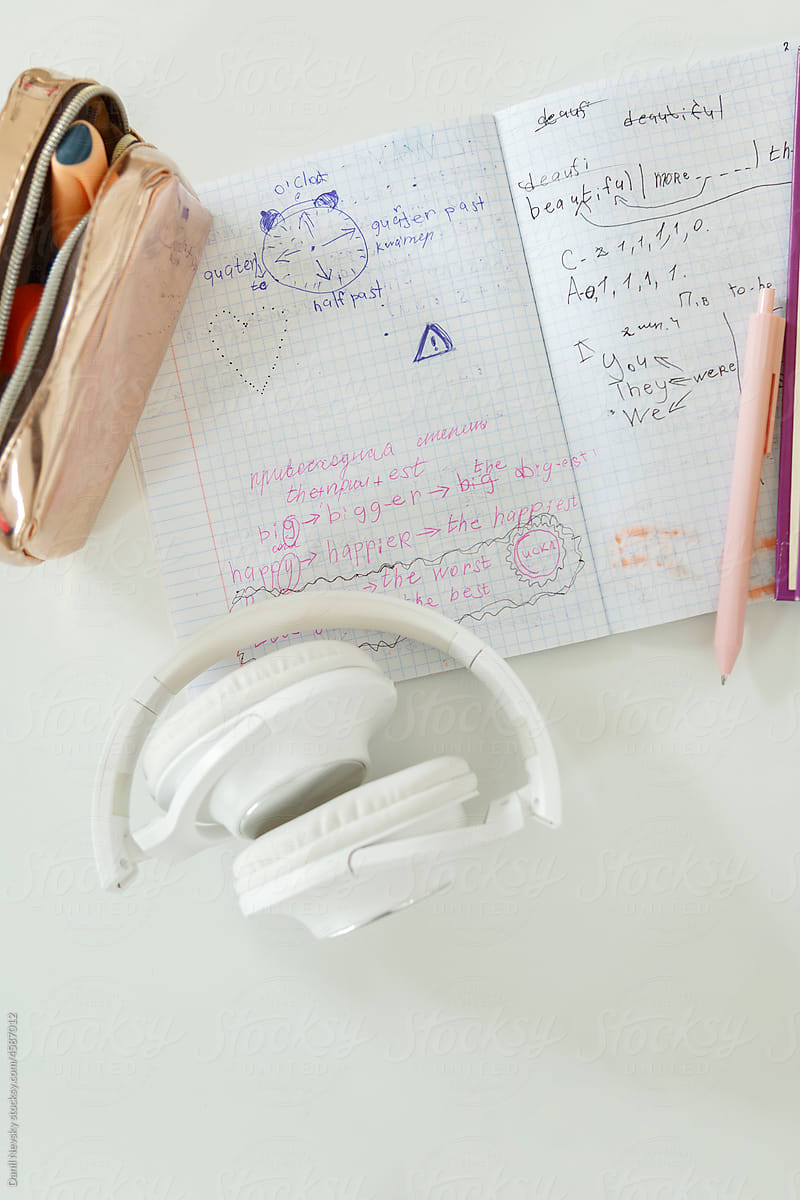 Stationery and headphones on desk