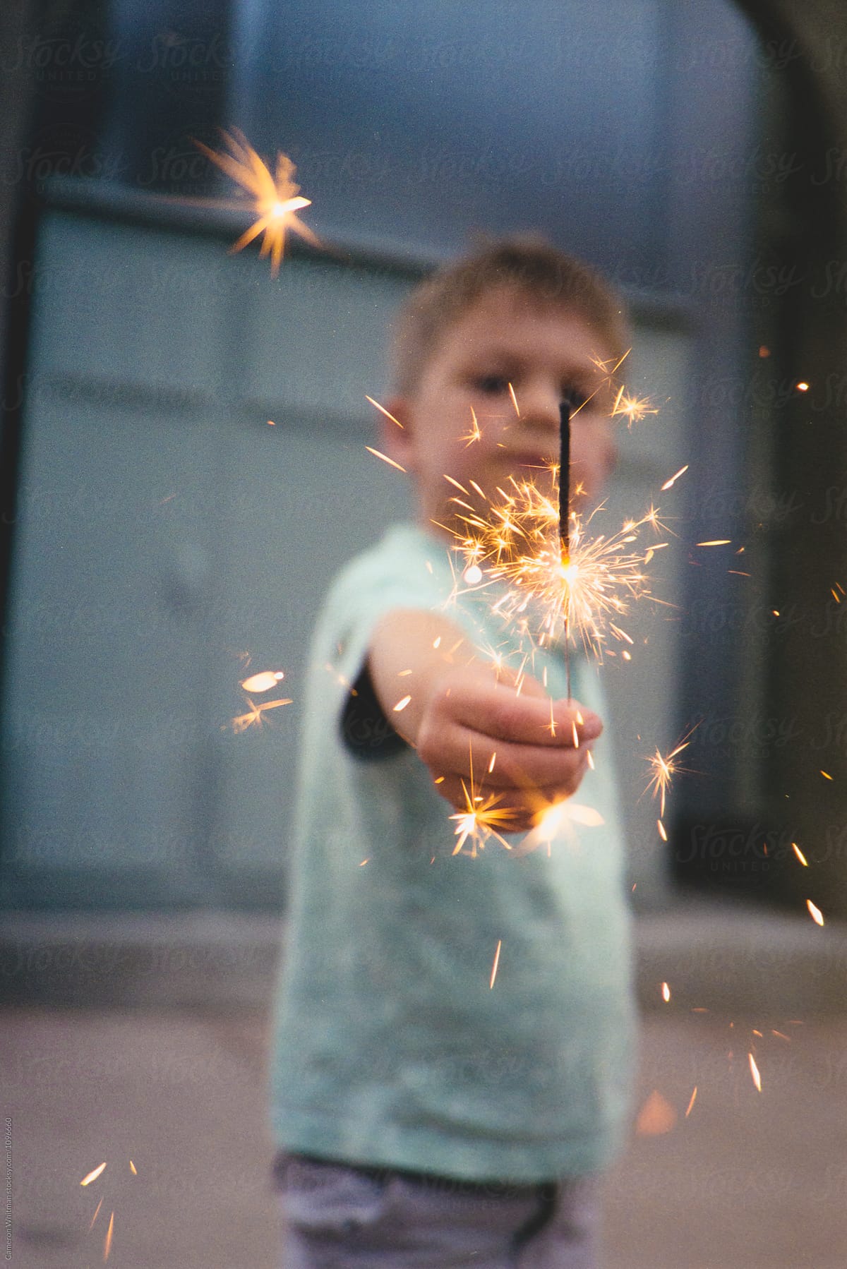 Young boy holding a sparkler