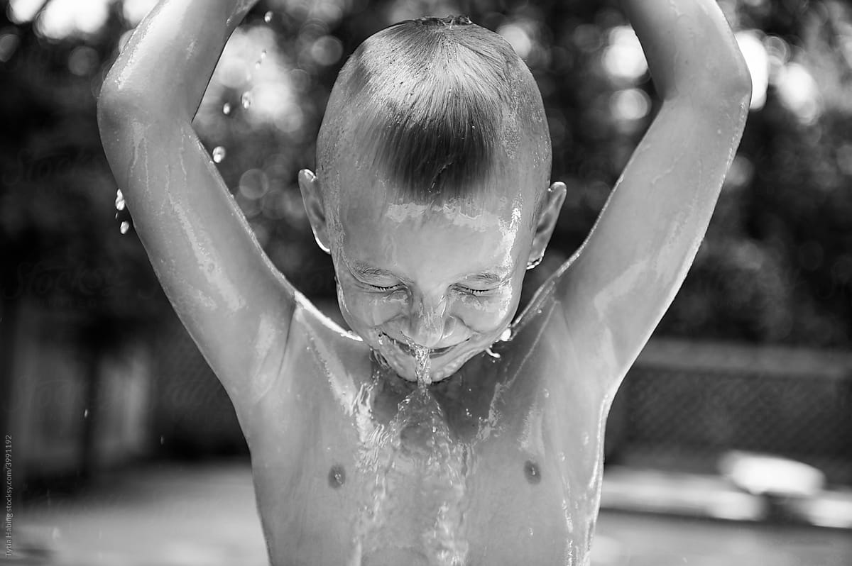 Young Boy Pouring Water over His Head