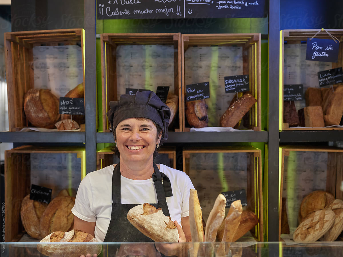 Smiling bakery saleswoman in front of the counter
