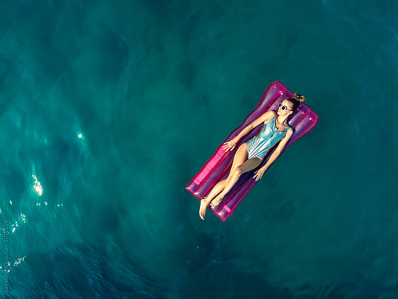 Overhead View of a Woman on a Pink Sea Mattress