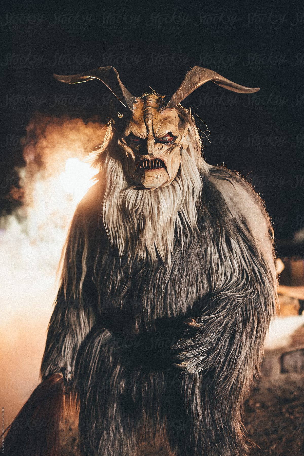 krampus with fire in the background - coming out of hell