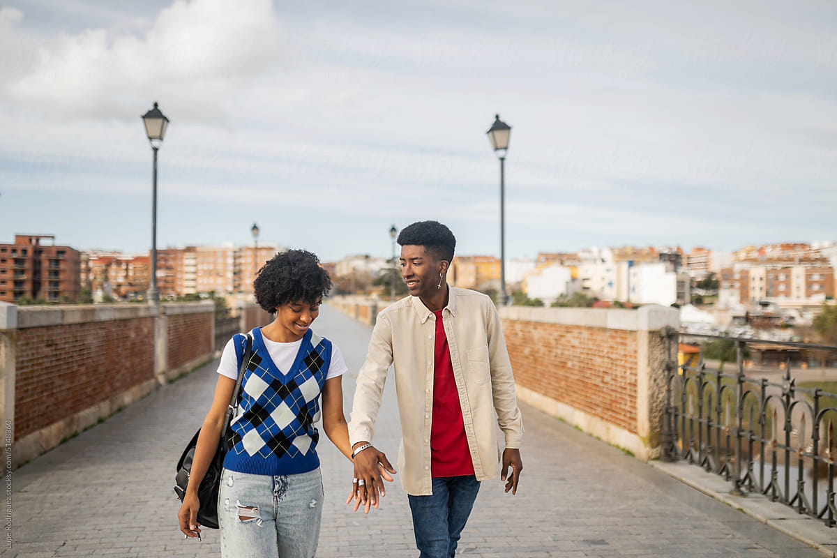 young black couple walking happily in the city