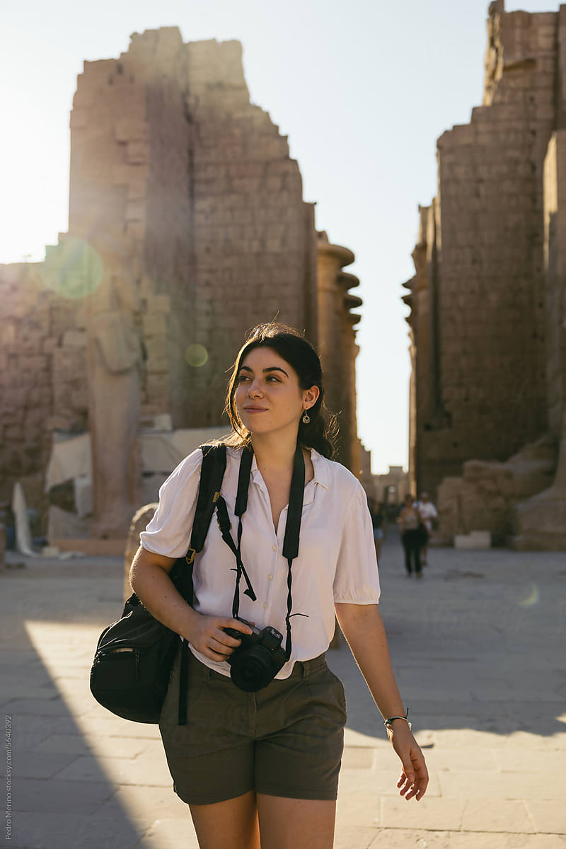 Smiling photographer walking in the Karnak Temple