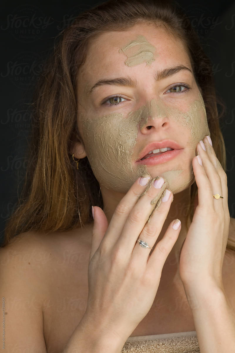 young woman applying beauty mask