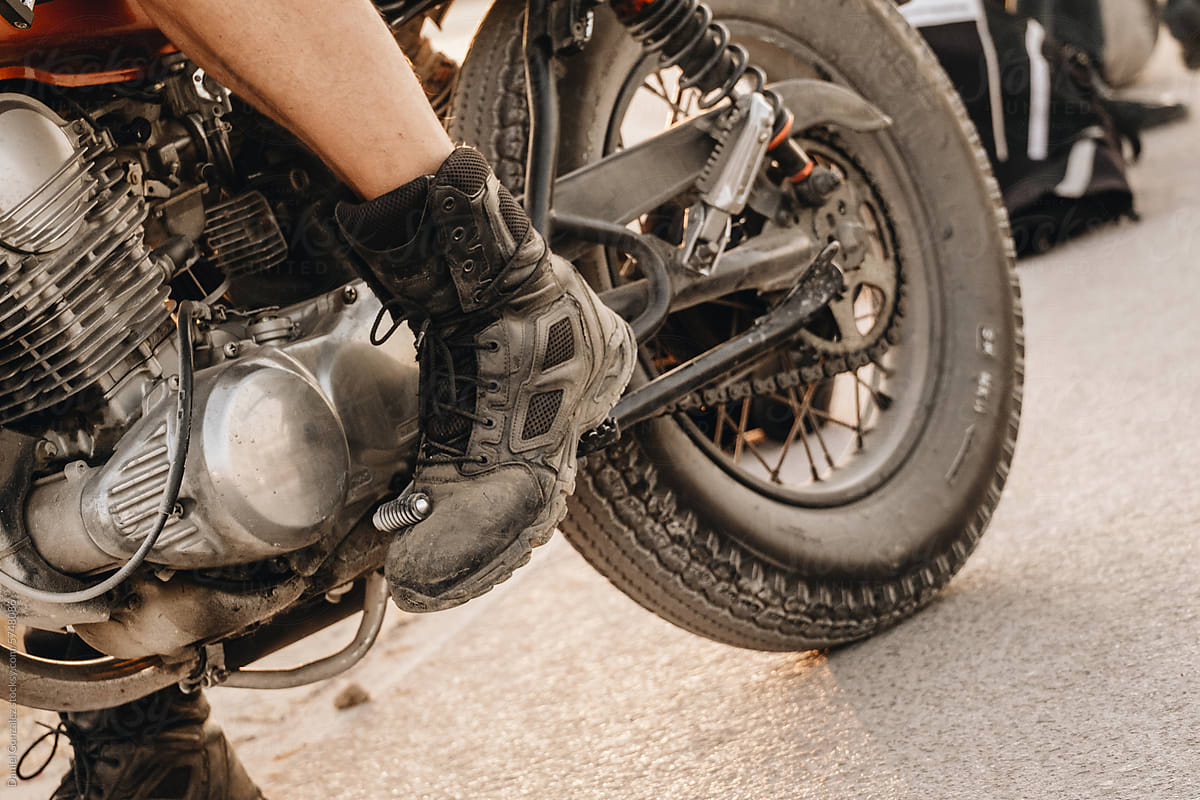 Detail of a biker\'s foot on his motorcycle