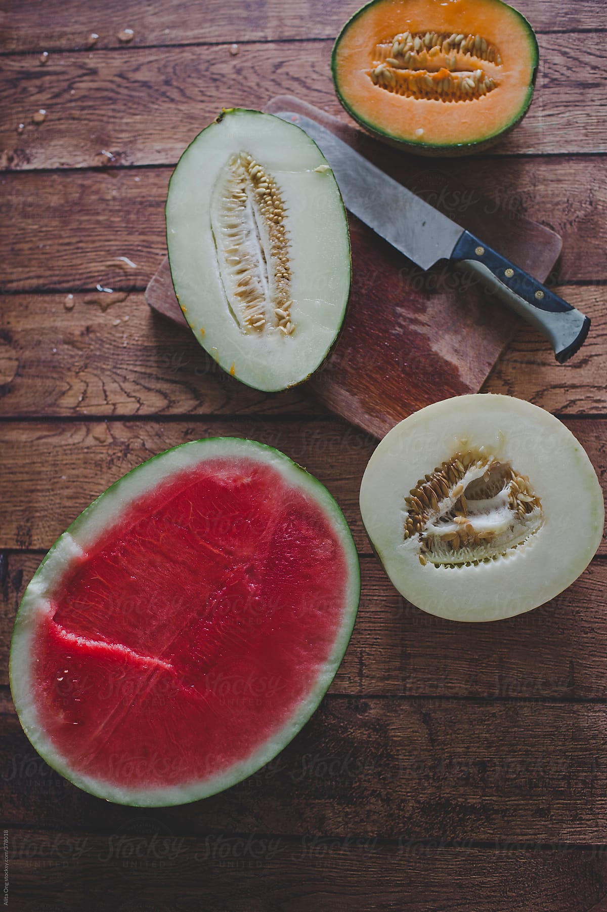 Melons on wooden background from above