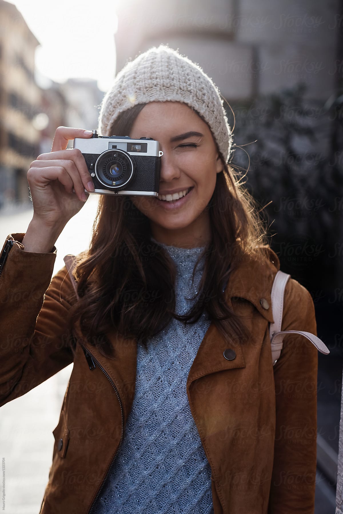 Woman taking pictures with her analog vintage camera.