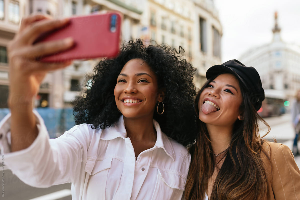 African american and asian women taking a selfie