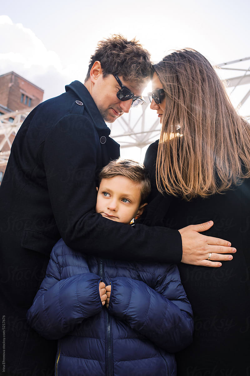 Outdoor portrait of a stylish family of three