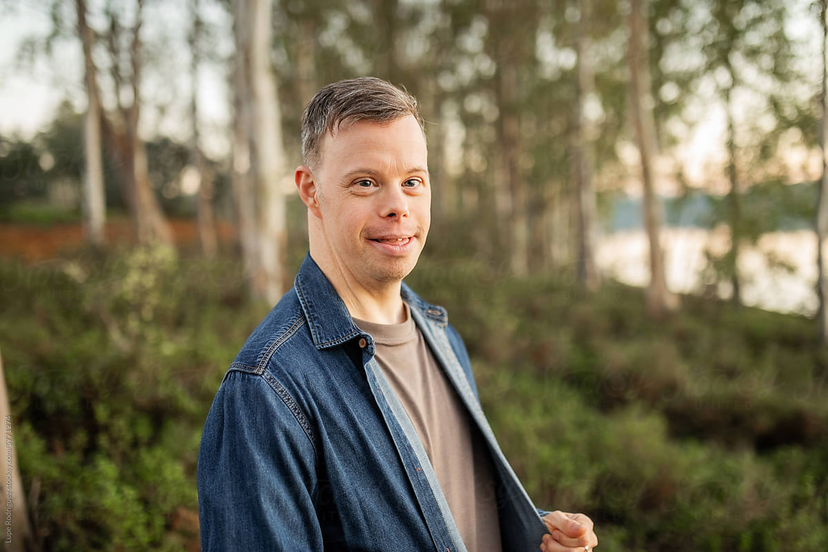 portrait of young man with down syndrome in nature