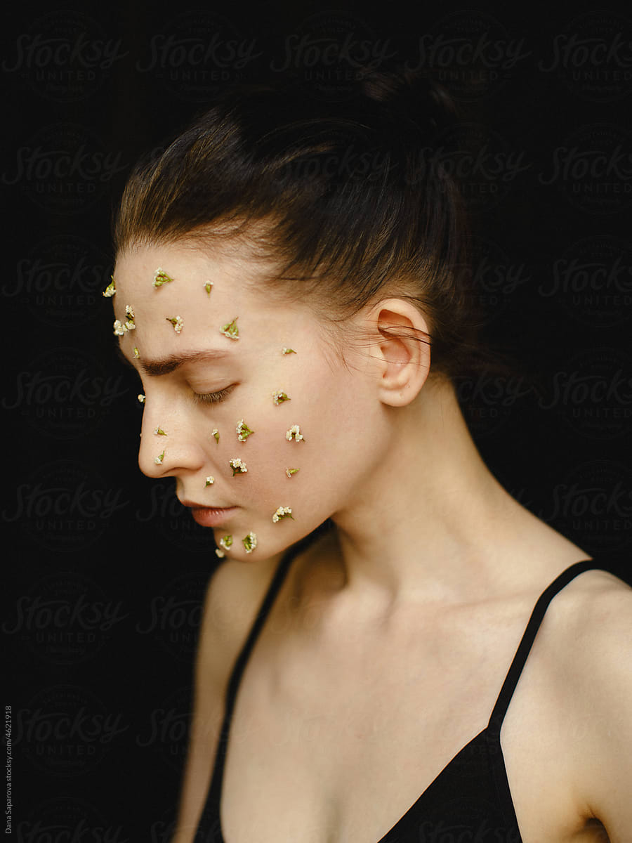 Woman with small flowers on her face
