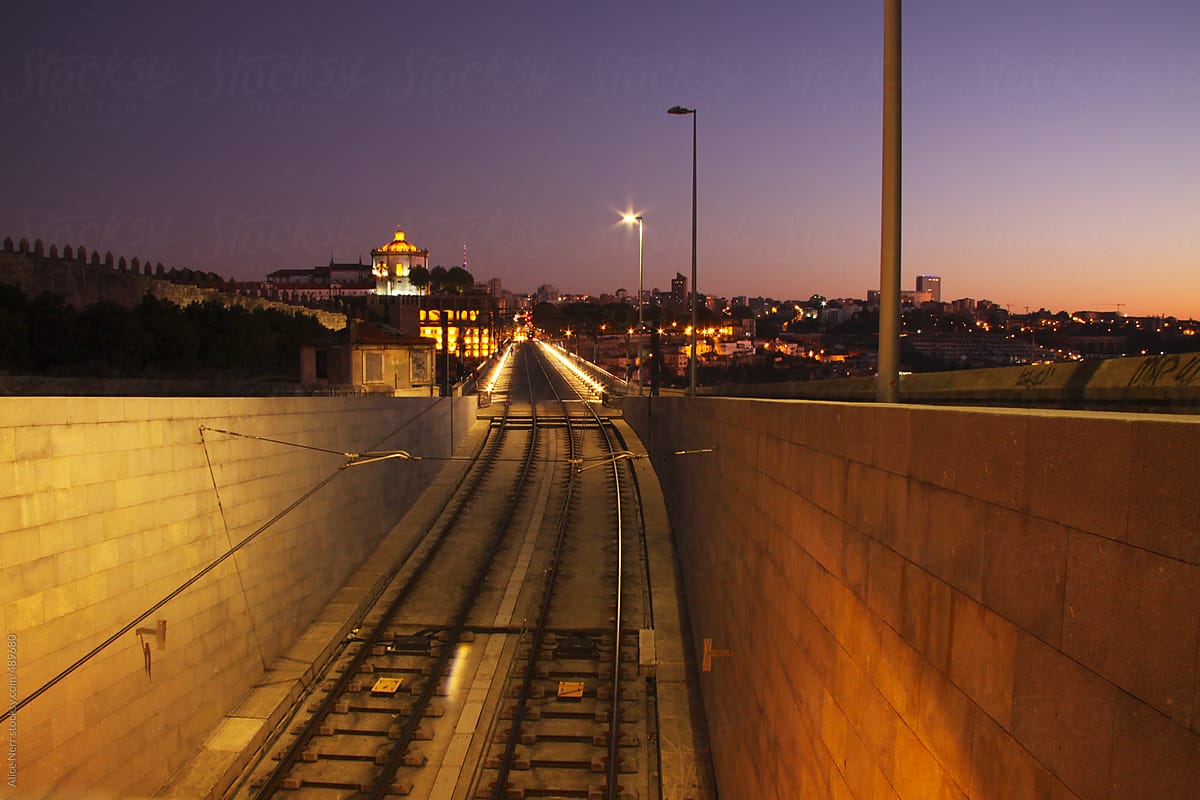 Illuminated railway through the urban city area