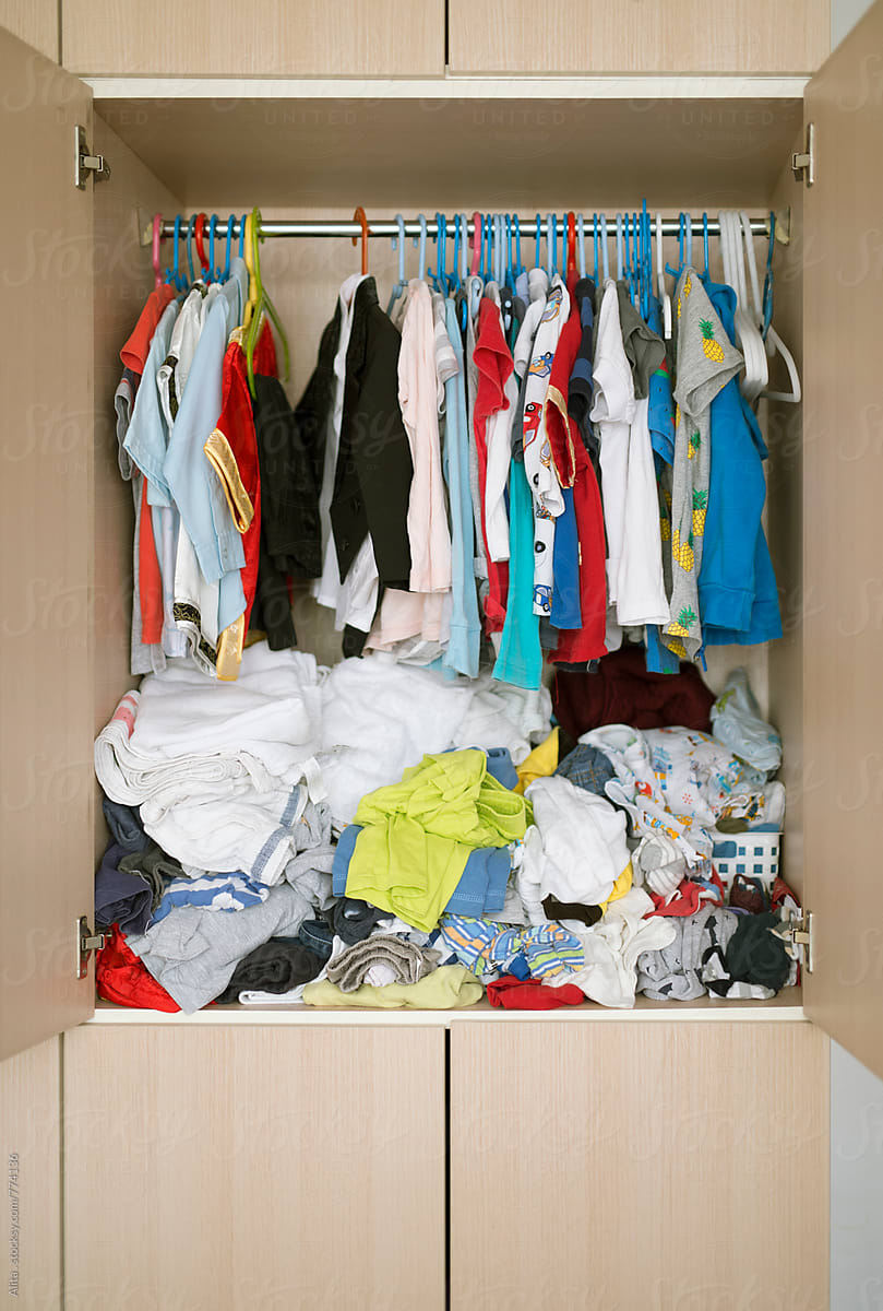 Messy kid\'s wardrobe BEFORE major decluttering and purging as new year resolution