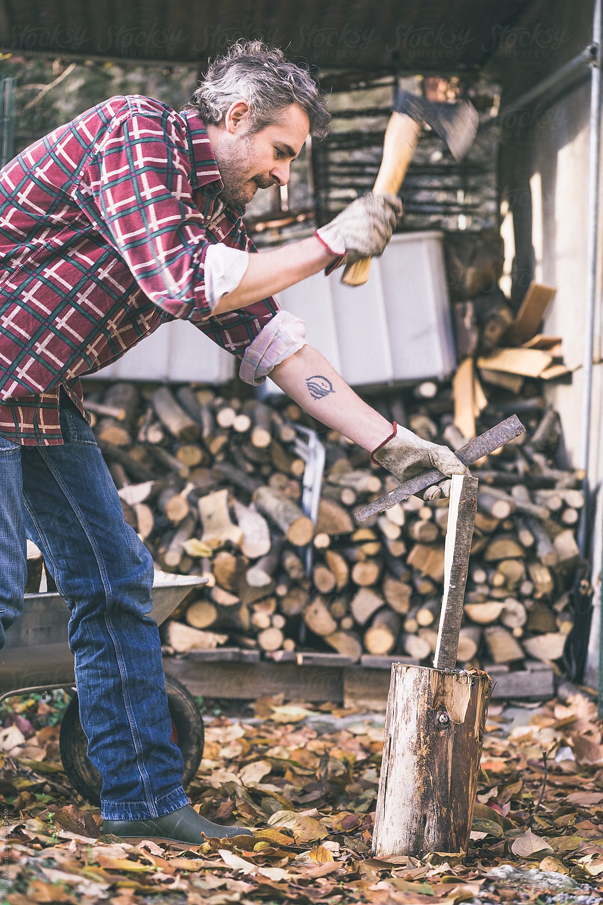 Man cutting firewood with ax