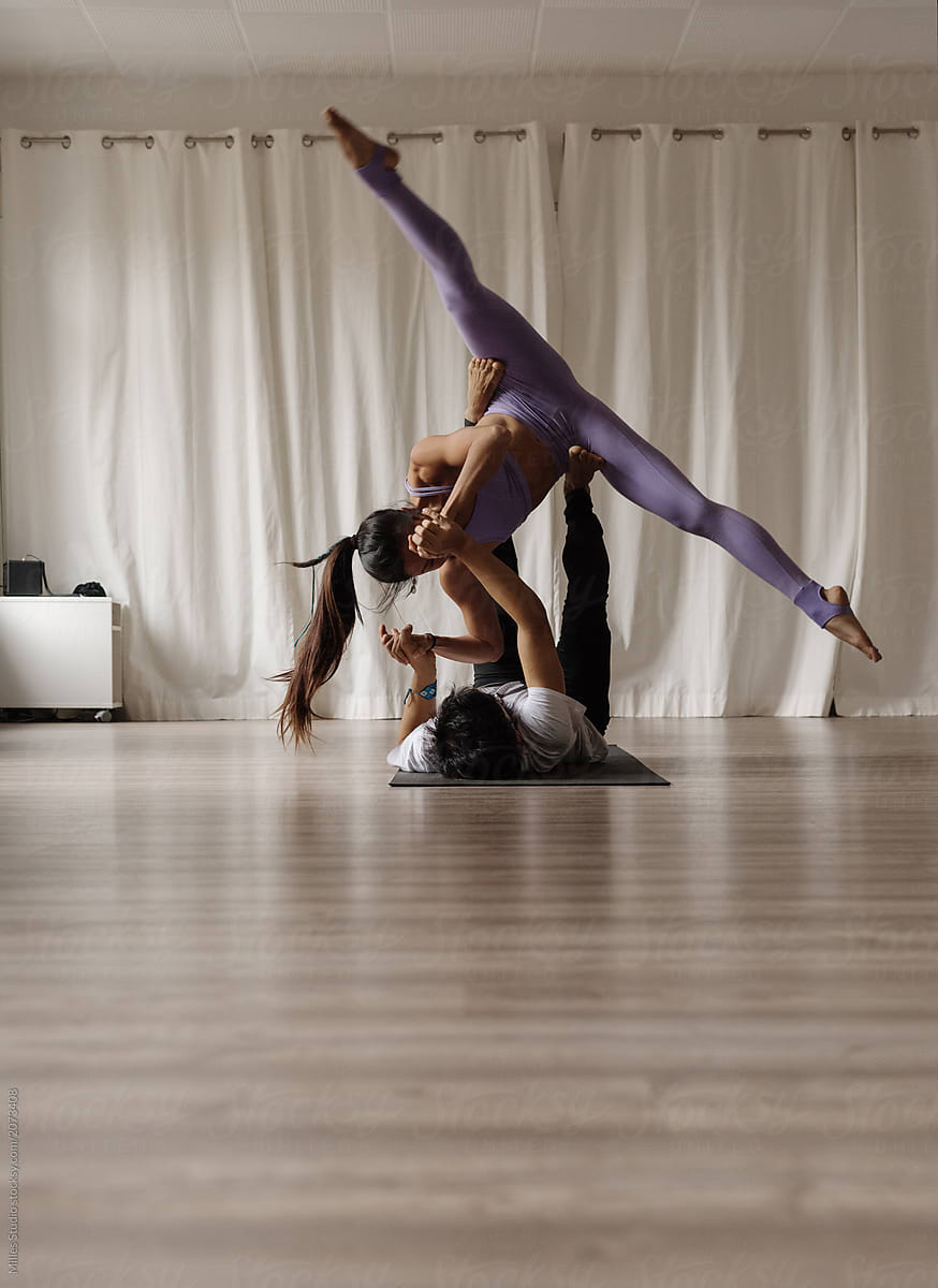 Gymnastic couple in graceful yoga posture