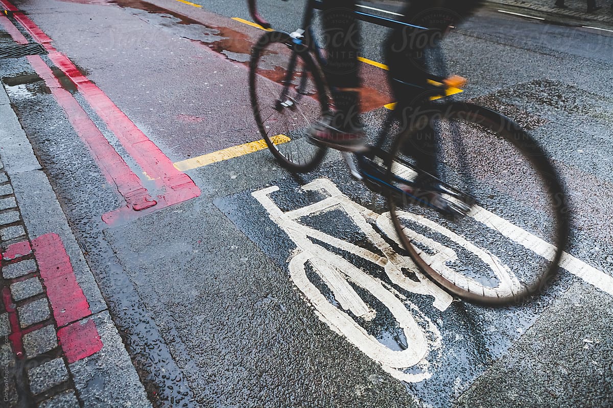 Cycling Commuter on Wet Bicycle Lane