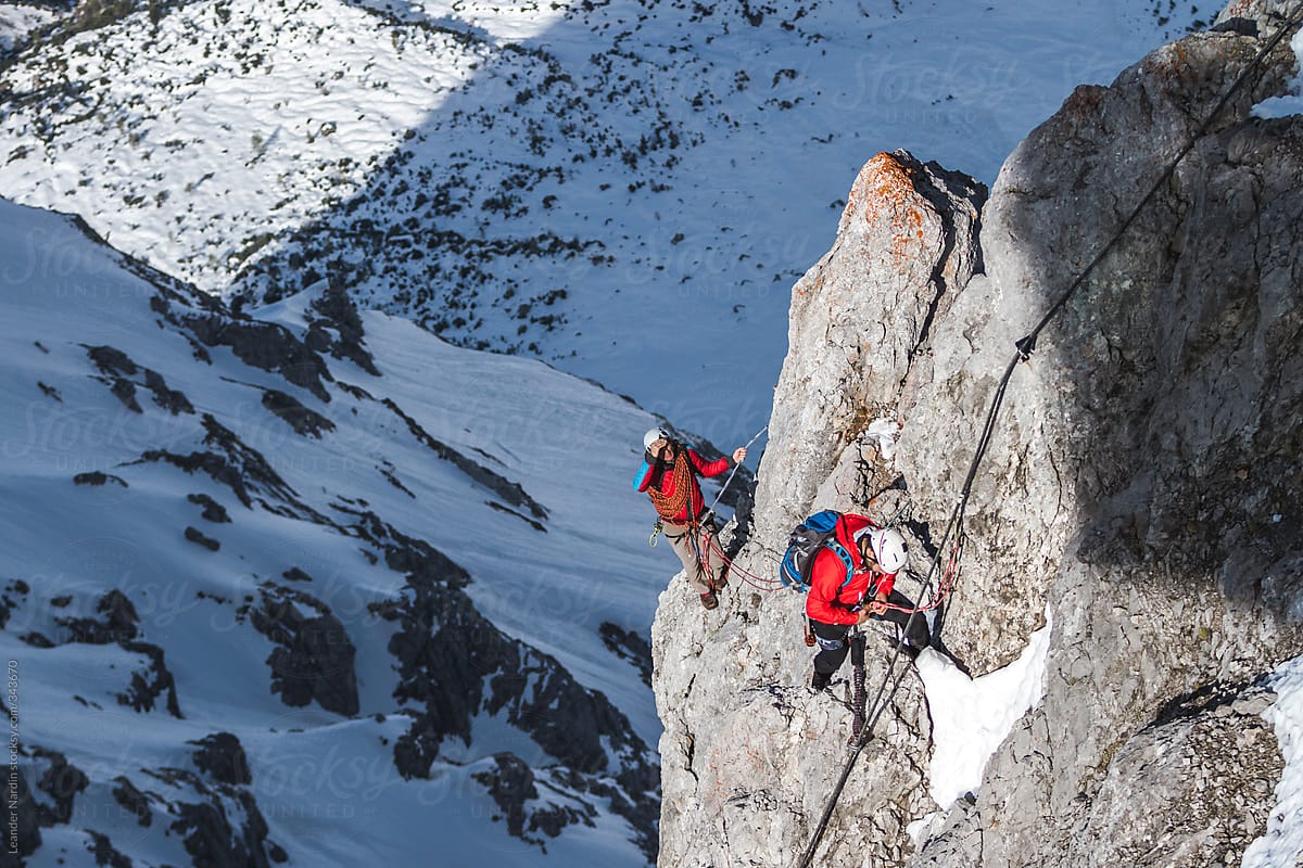 Two Mountain Climbers Rappeling And Fixing Ropes On A Mountain by Stocksy  Contributor Akela - From Alp To Alp - Stocksy