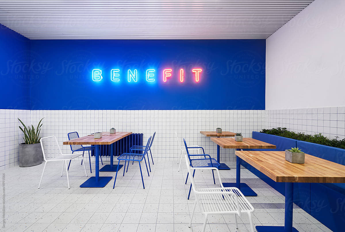 Modern cafe with neon, chairs and tables