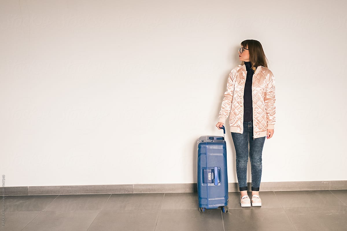 Stylish woman with blue baggage