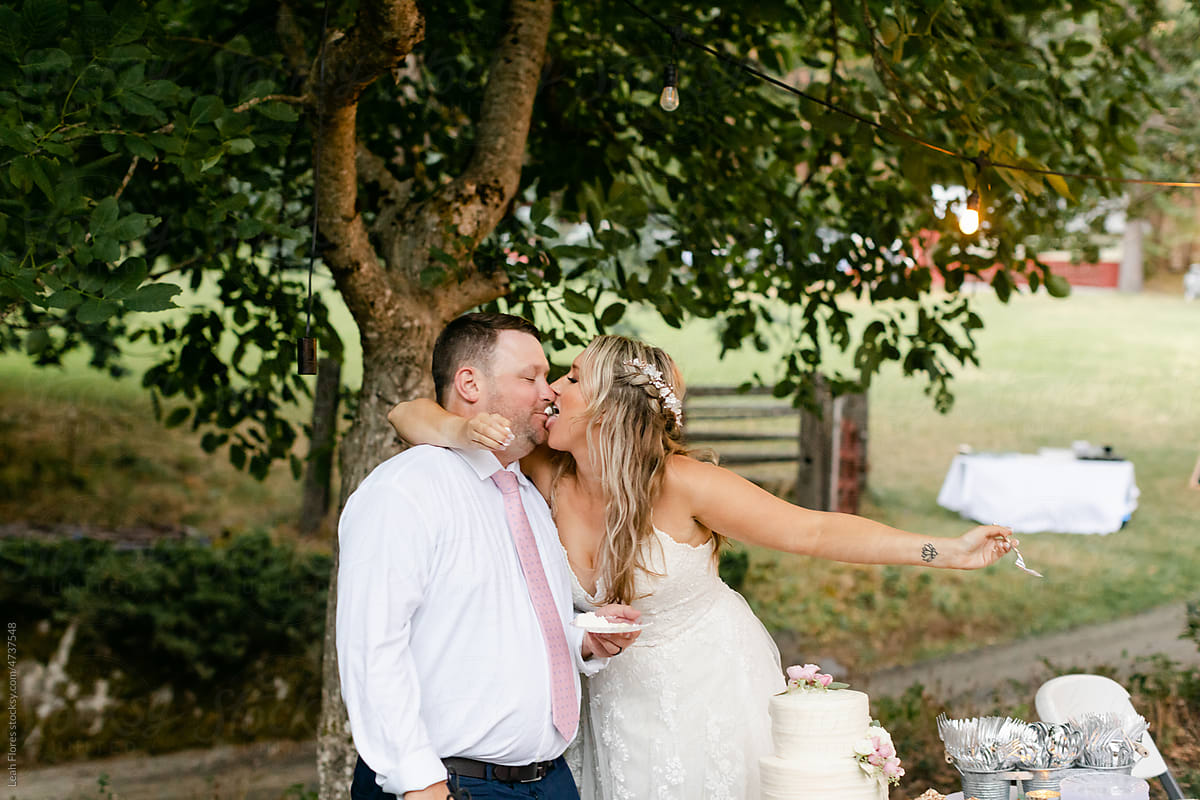 Bride Licking Cake\'s Frosting off of Groom\'s Mouth