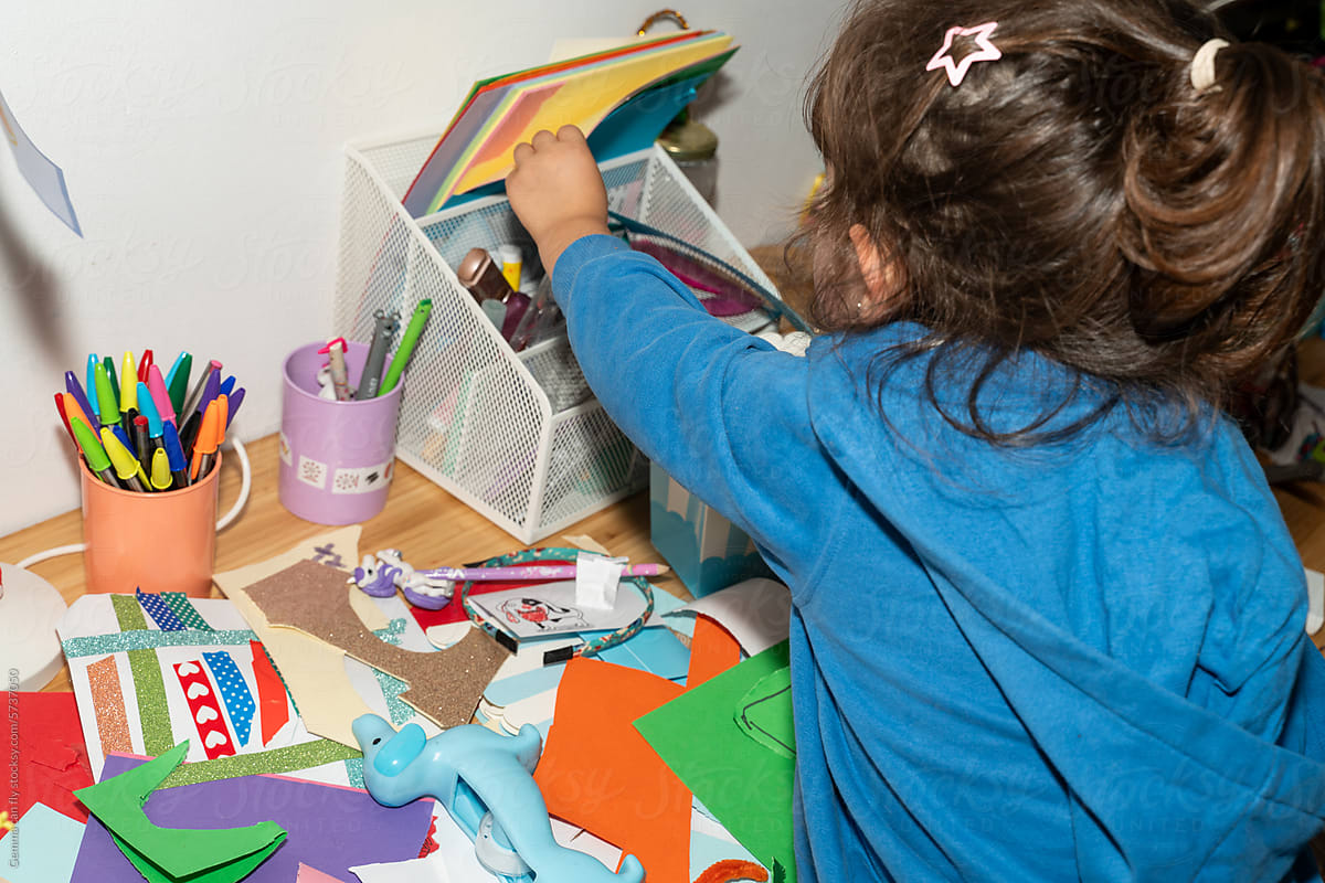 Messy craft kid. Little girl doing art crafts