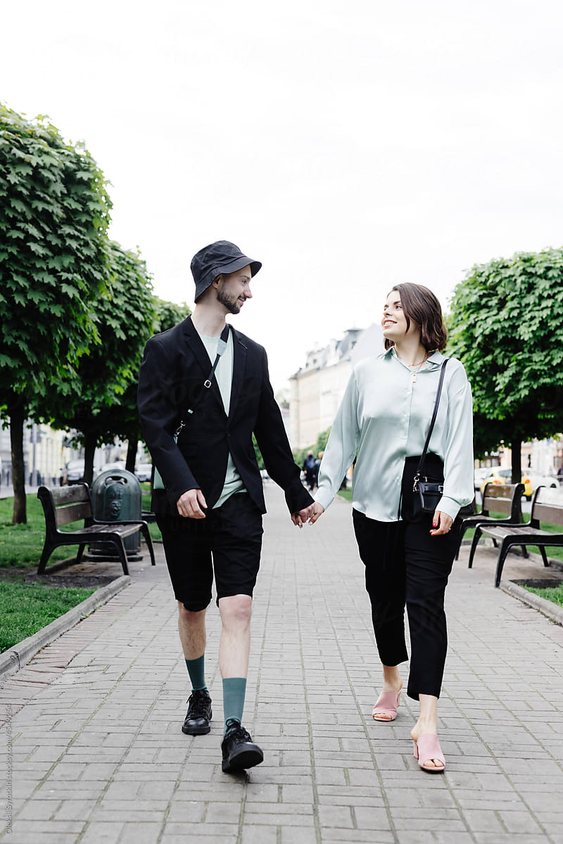 Couple walking rttogether through park
