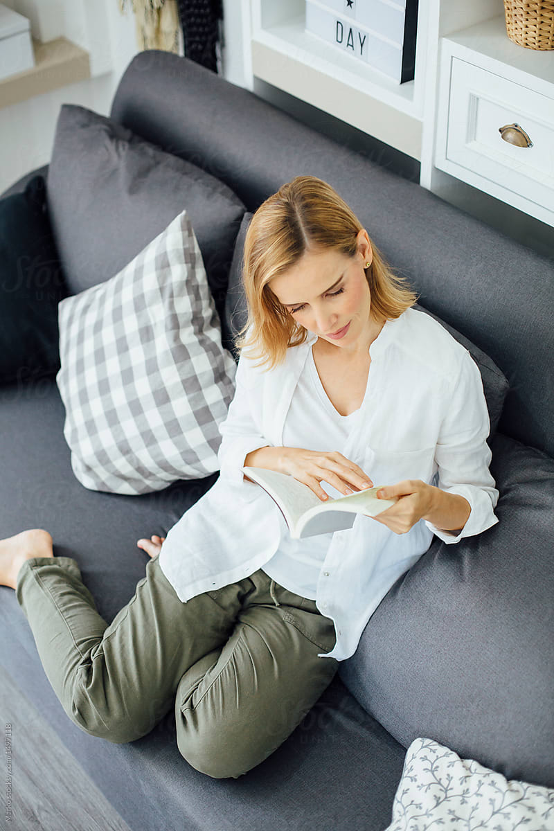 Caucasian woman reading book at home