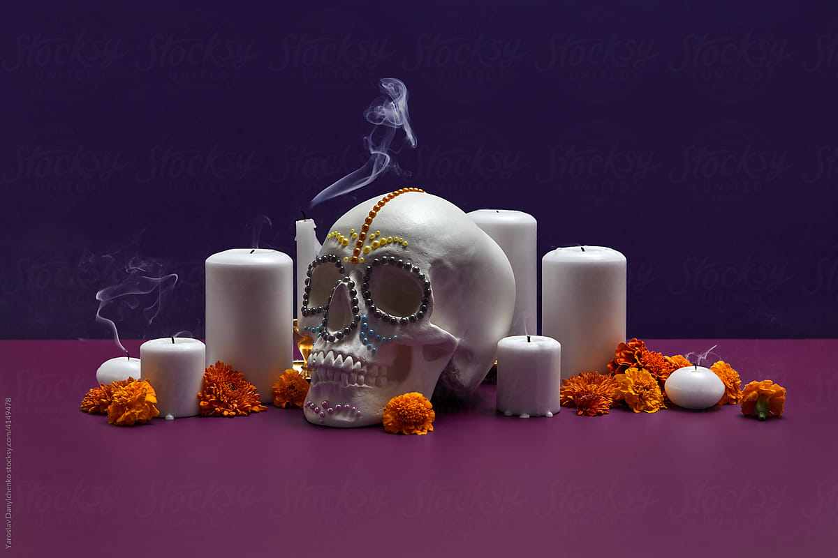 Skull with flowers and smoke from candles