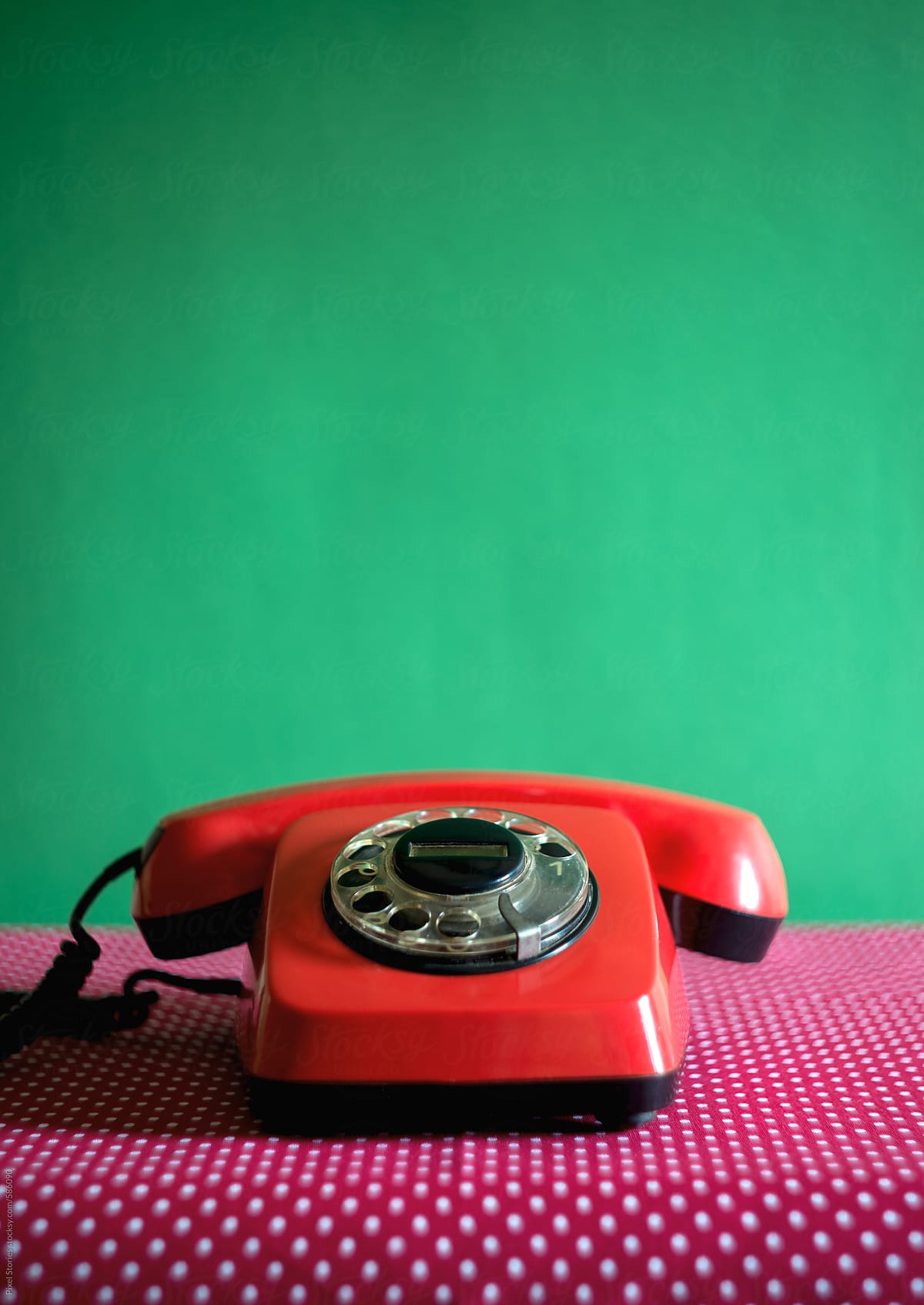 Red vintage landline phone with rotary dial