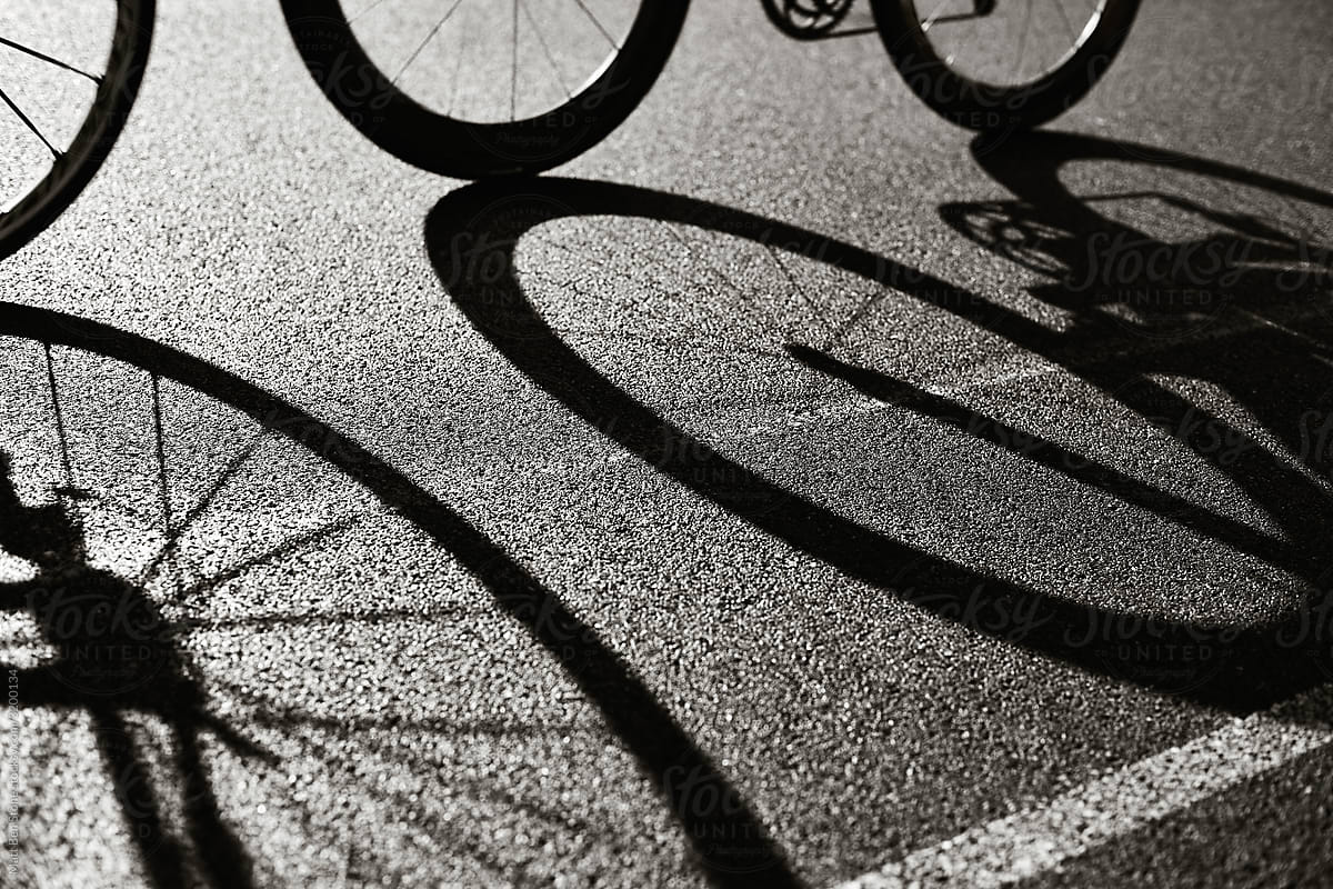 Road racing Cycling silhouette of front and rear bike wheel on a pavement