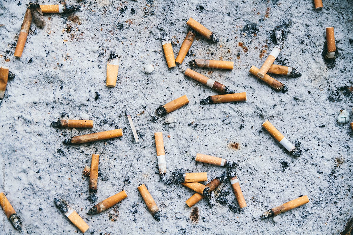 Tobacco cigarettes on sand ashtray