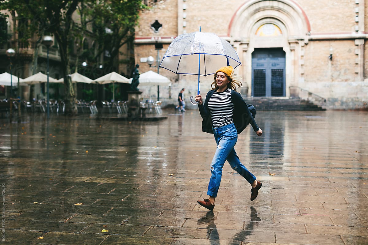 Woman Running Holding An Umbrella On A Rainy Day By Bonninstudio Woman Running Holding An Umbrella On A Rainy Day By Bonninstudio