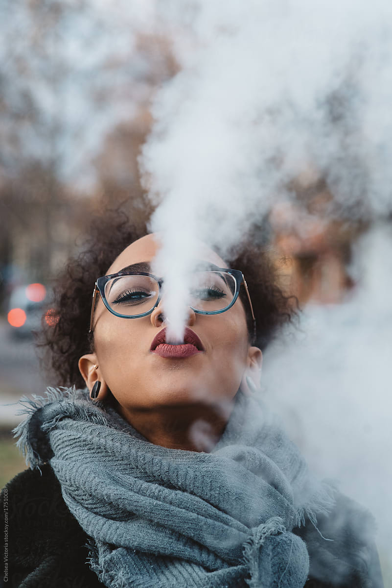A Woman Blowing Smoke Out Of Her Mouth By Stocksy Contributor Chelsea Victoria Stocksy