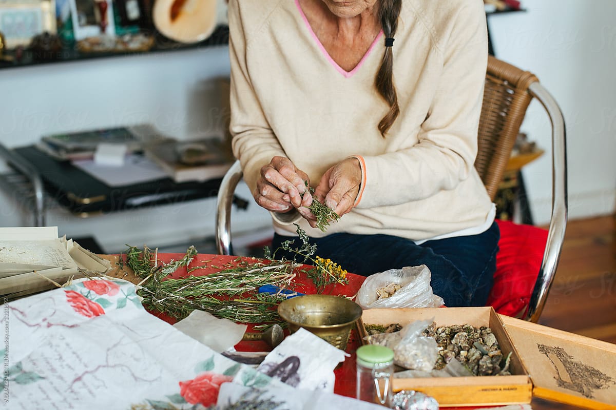 Closeup of Senior Woman Making Natural Smudge Stick With Dried Rosemary